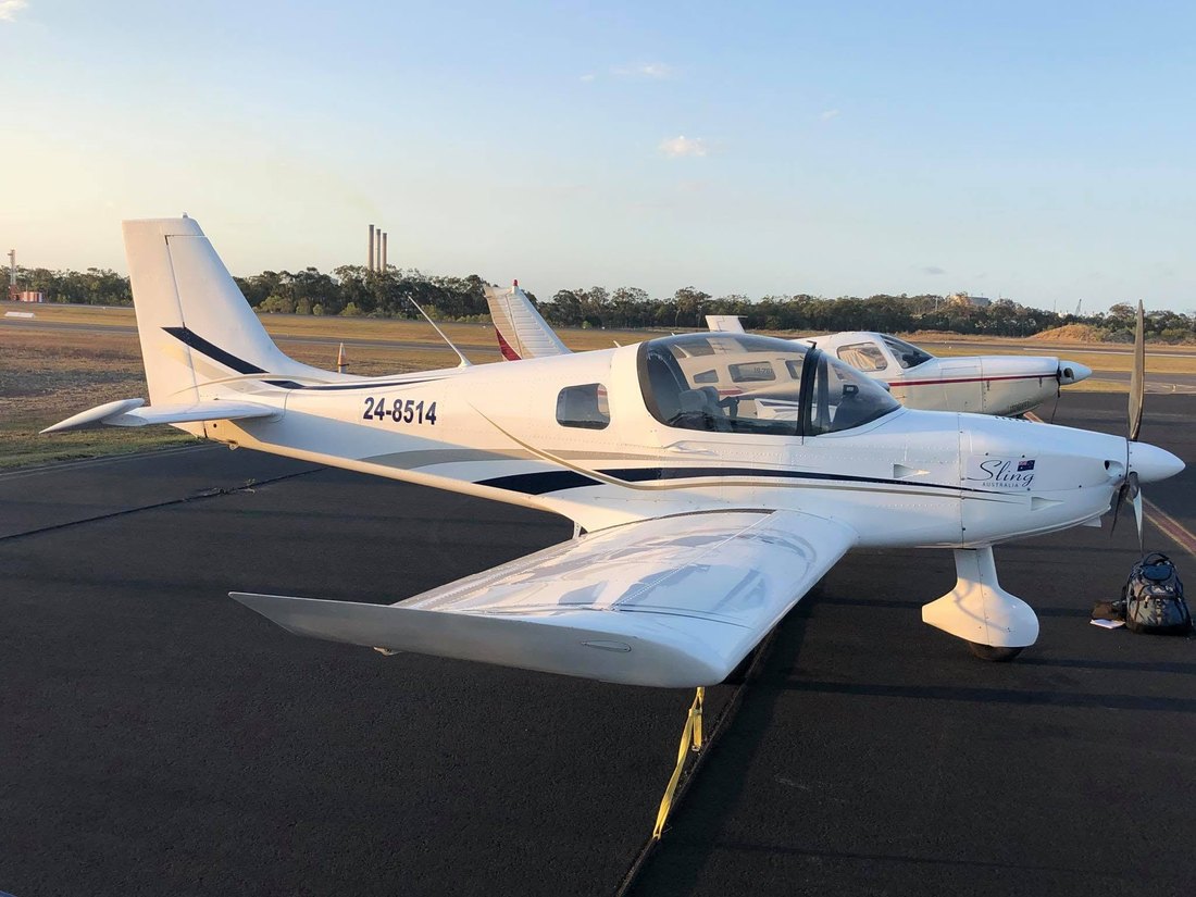 Gladstone Flying Training's Sling aircraft on the apron at Gladstone Airport in golden light